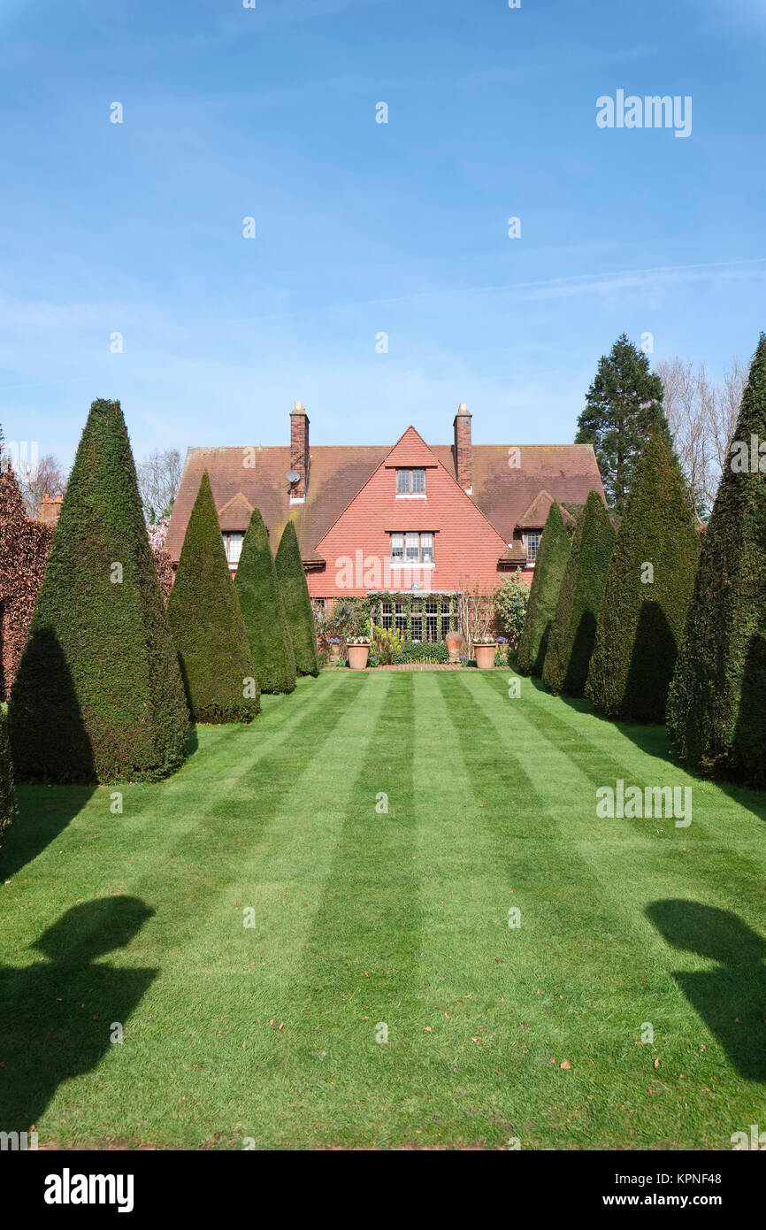 Striped Lawn and Clipped Yews The Old Vicarage Arts and Crafts House at East Ruston Norfolk Stock Photo