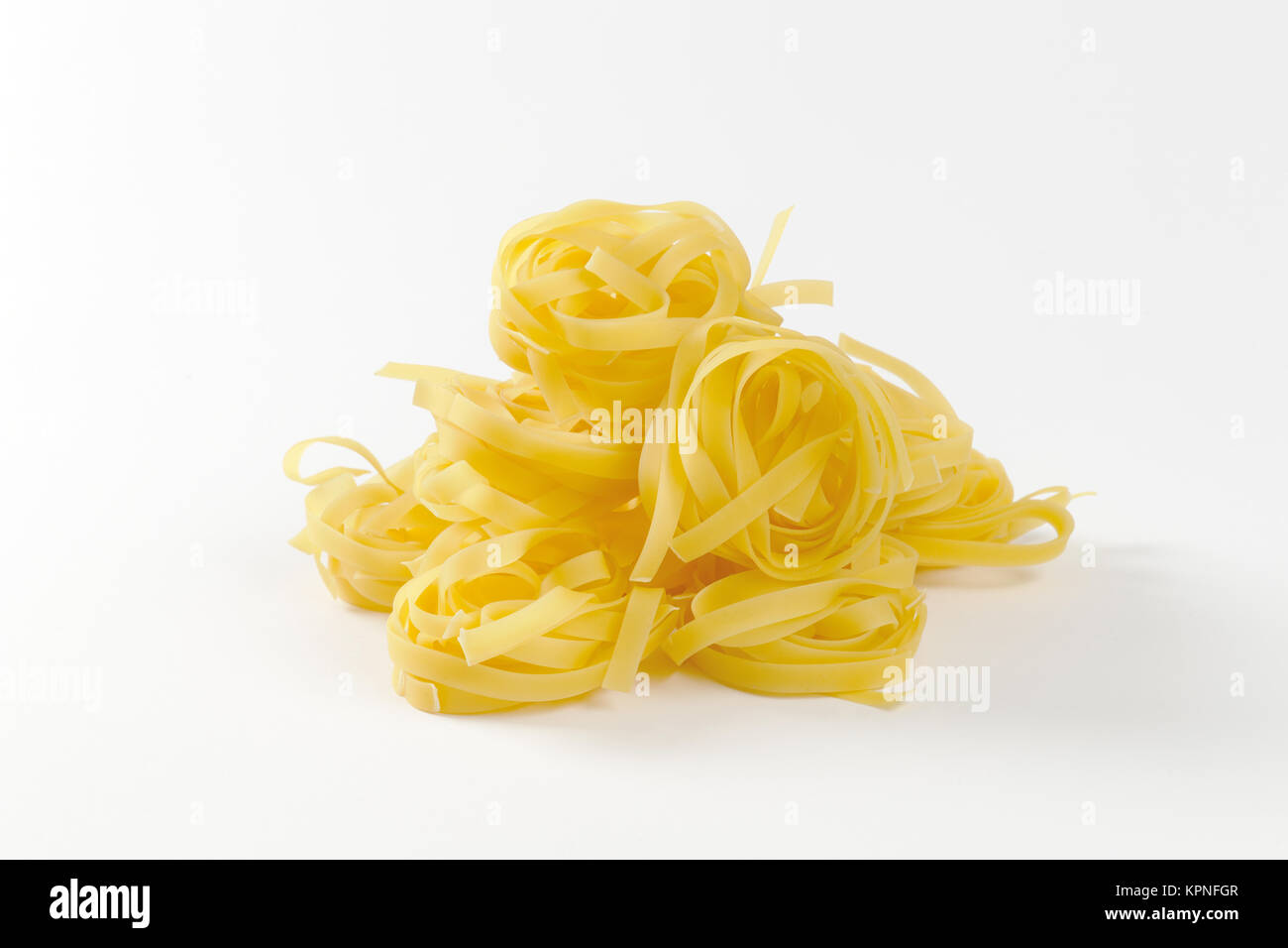 Nests of dry pasta tagliatelle Stock Photo Alamy
