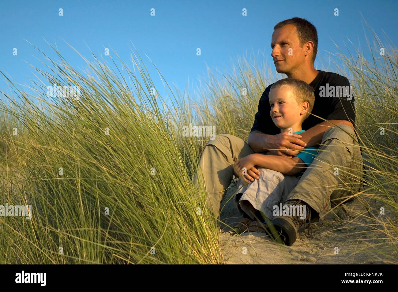 Boy With Father Looking Stock Photo