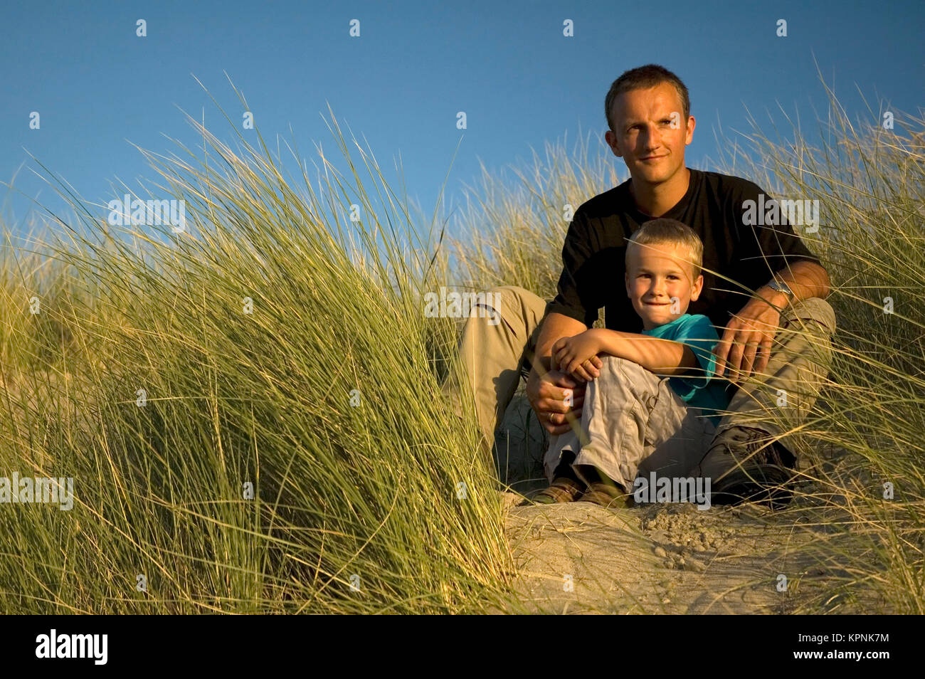 Father And Son Looking Away Stock Photo