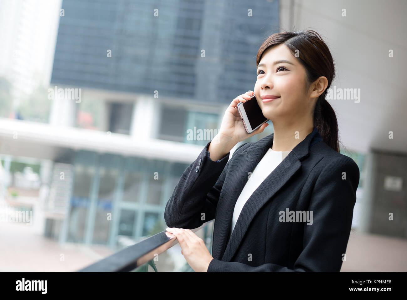 Businesswoman talk to mobile phone in Hong Kong city Stock Photo - Alamy