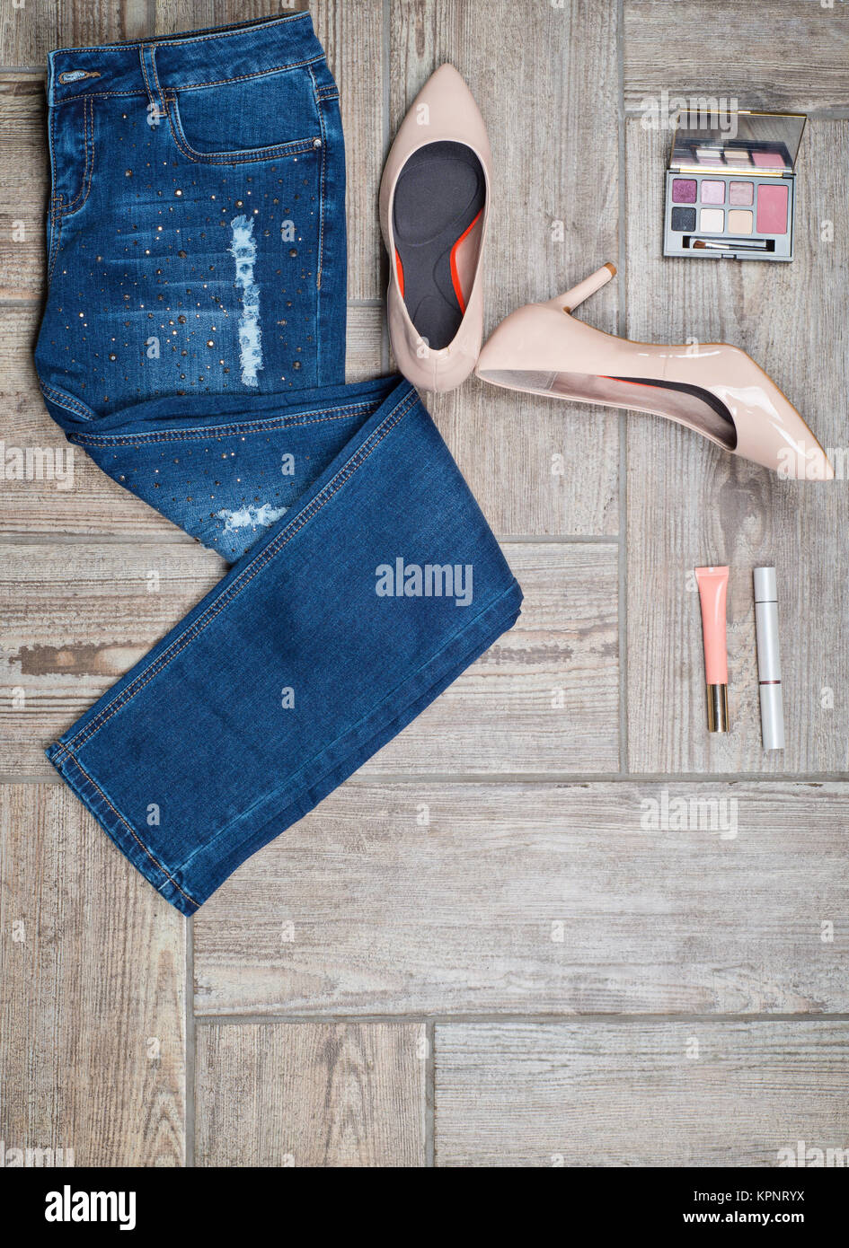 Flat lay photo of girl&#39 s jeans and accessories Stock Photo
