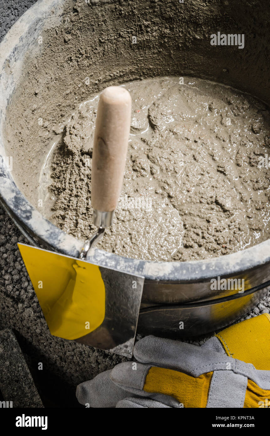 Tools for bricklayer bucket with a solution and a trowel Stock Photo