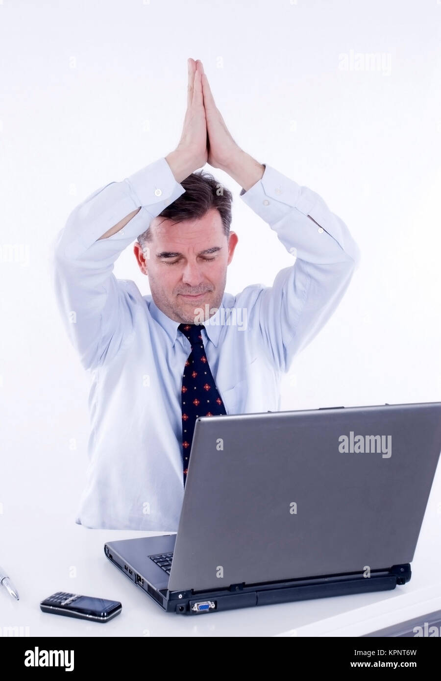 Model release , Geschaeftsmann, 50+, macht Joga am Arbeitsplatz - business man does yoga at work Stock Photo