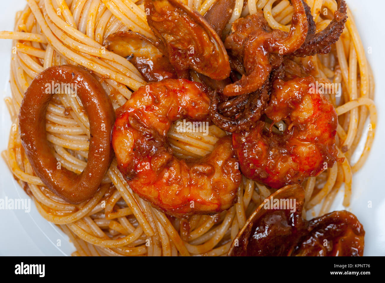 Italian seafood spaghetti pasta on red tomato sauce Stock Photo - Alamy