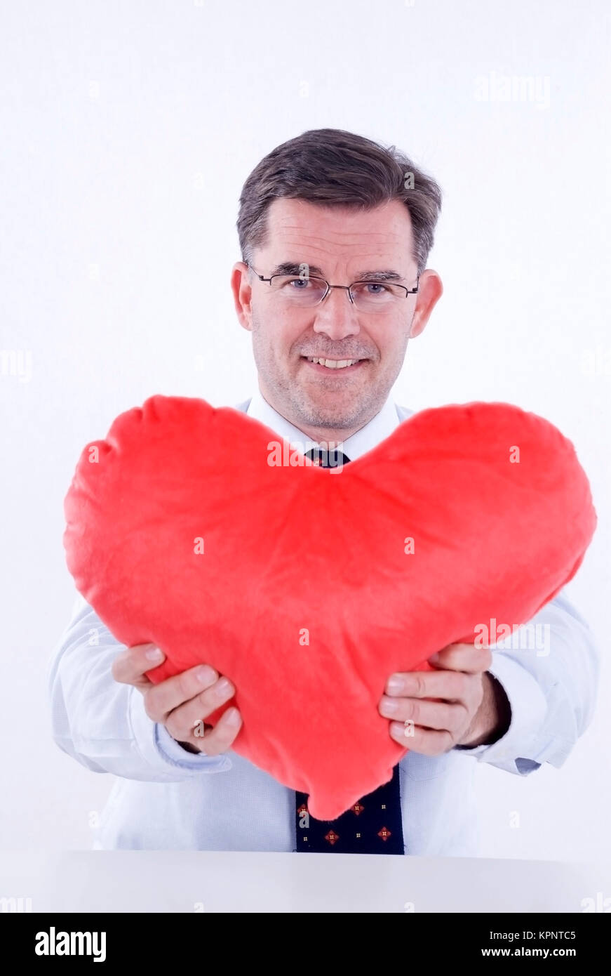 Model release , Attraktiver Mann, 50+, mit Stoffherz - attractive man, with heart Stock Photo