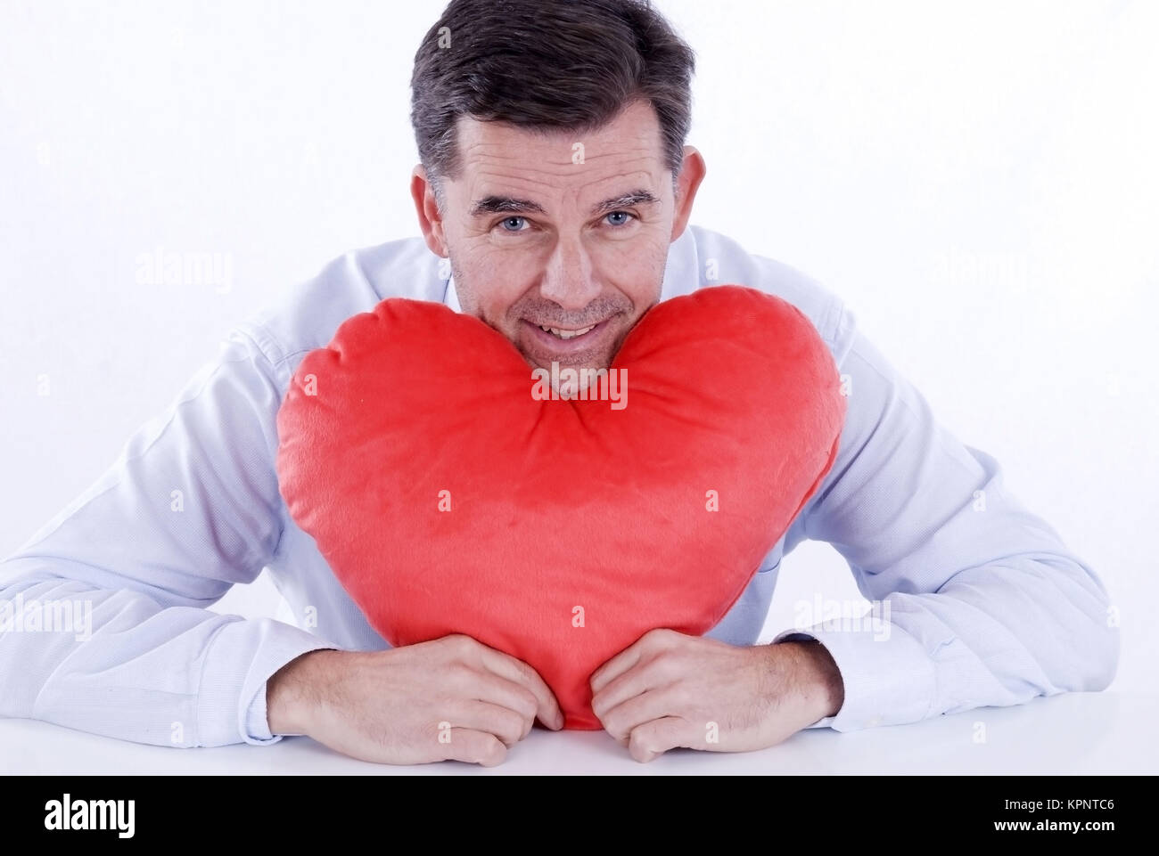 Model release , Attraktiver Mann, 50+, mit Stoffherz - attractive man, with heart Stock Photo