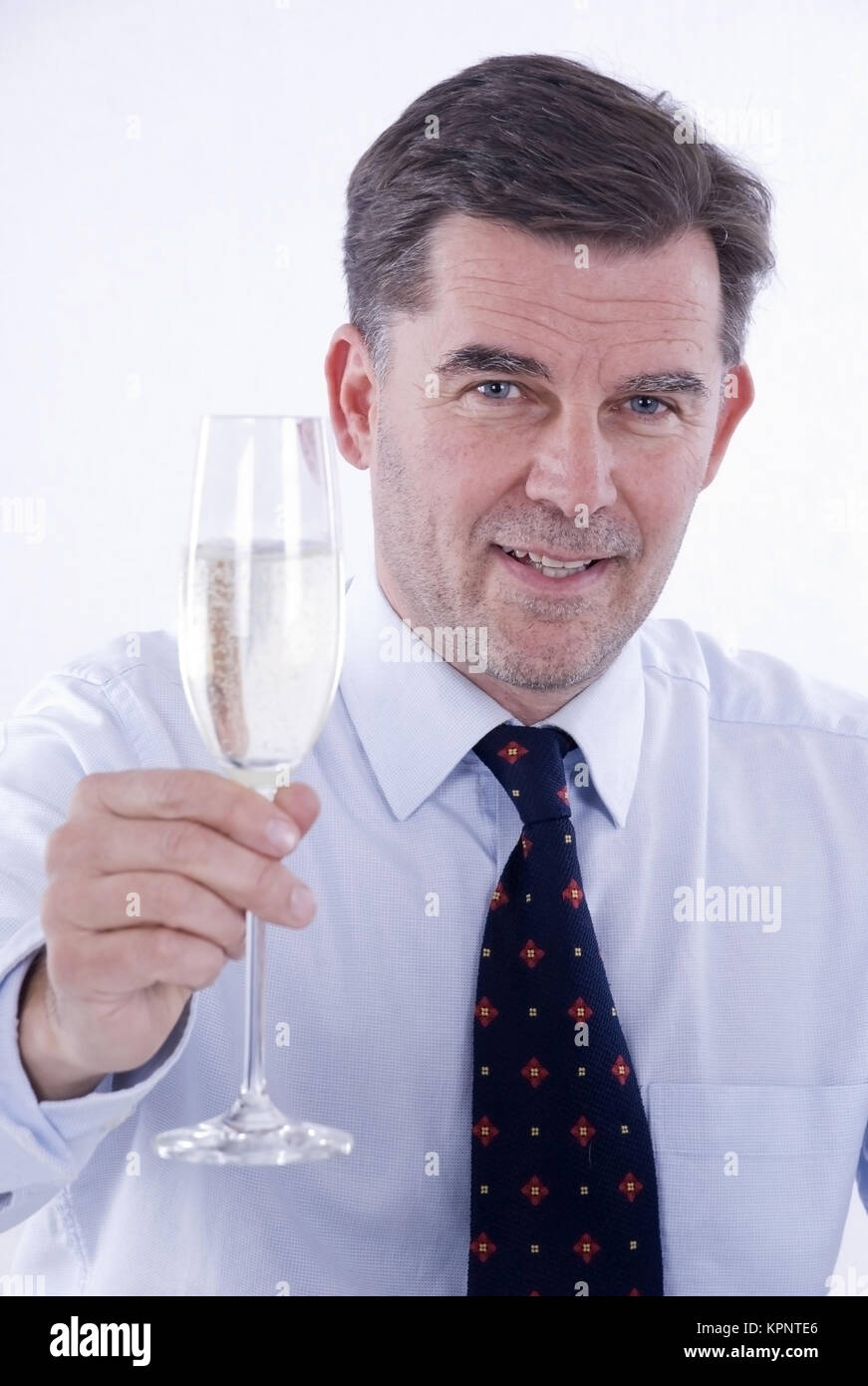Model release , Geschaeftsmann mit einem Glas Sekt in der Hand - business  man drinks sparkling wine Stock Photo - Alamy