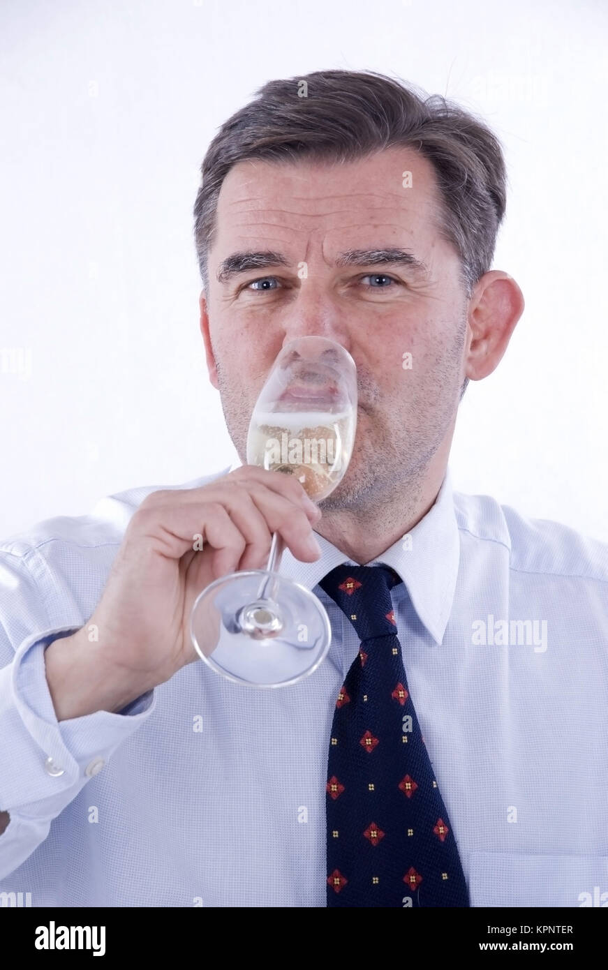 Model release , Geschaeftsmann trinkt ein Glas Sekt - business man drinks sparkling wine Stock Photo