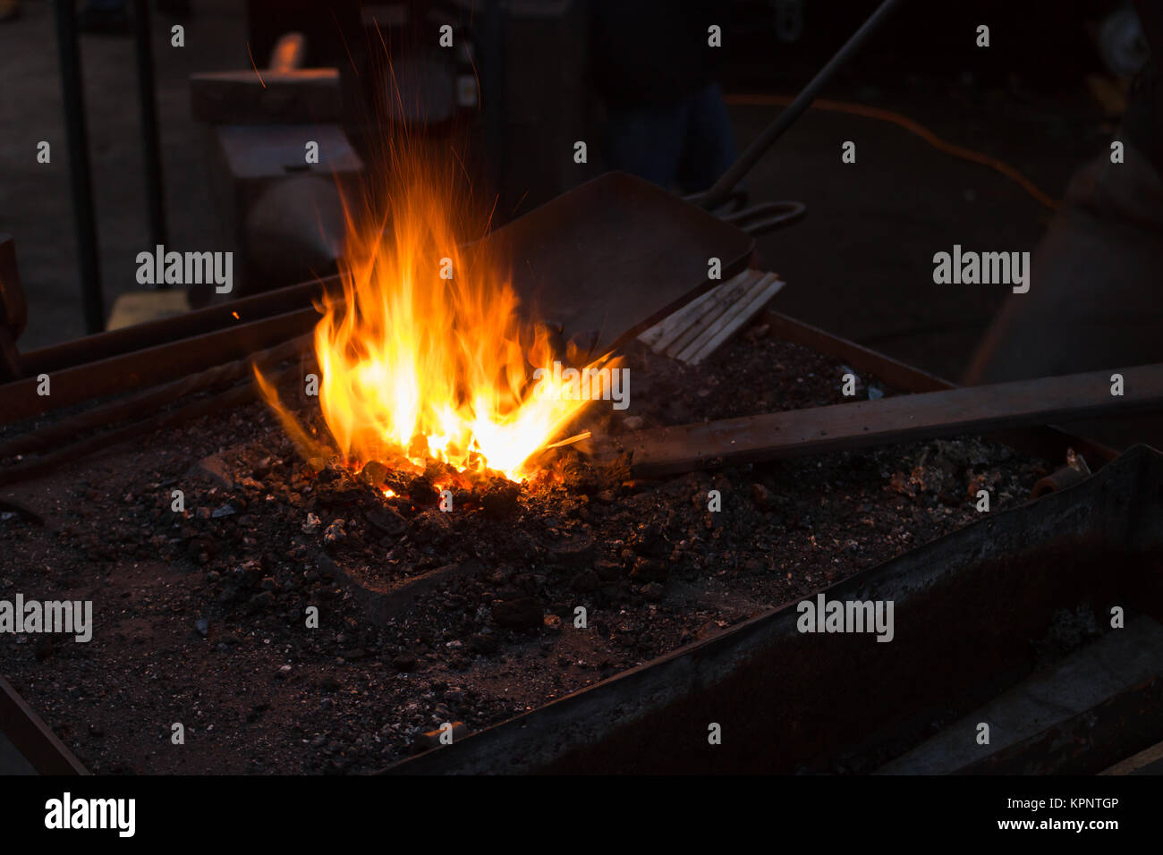 Blacksmiths coals burning for iron work on christmas market Stock Photo