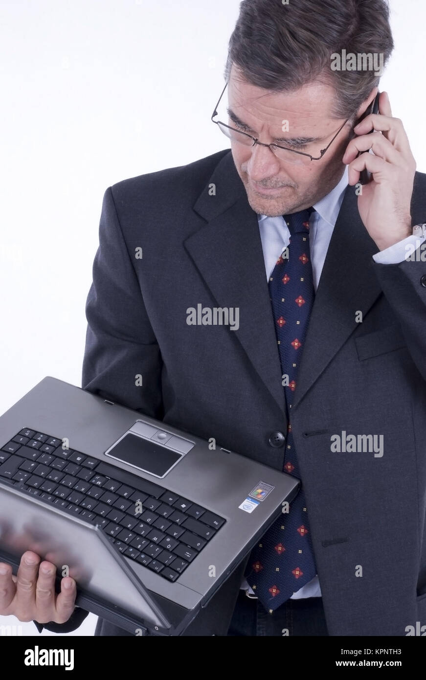 Geschaeftsmann, 50+, mit Laptop und Handy - business man with laptop Stock Photo