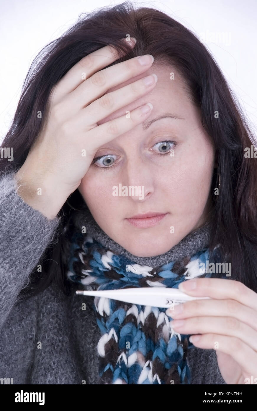 Model release , Junge Frau misst Fieber - woman with clinical thermometer Stock Photo