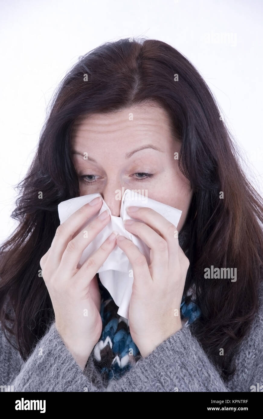 Model release , Junge Frau mit Verkuehlung schneuzt sich - woman with cold Stock Photo