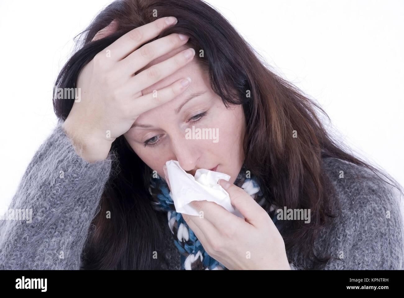 Model release , Junge Frau mit Verkuehlung schneuzt sich - woman with cold Stock Photo