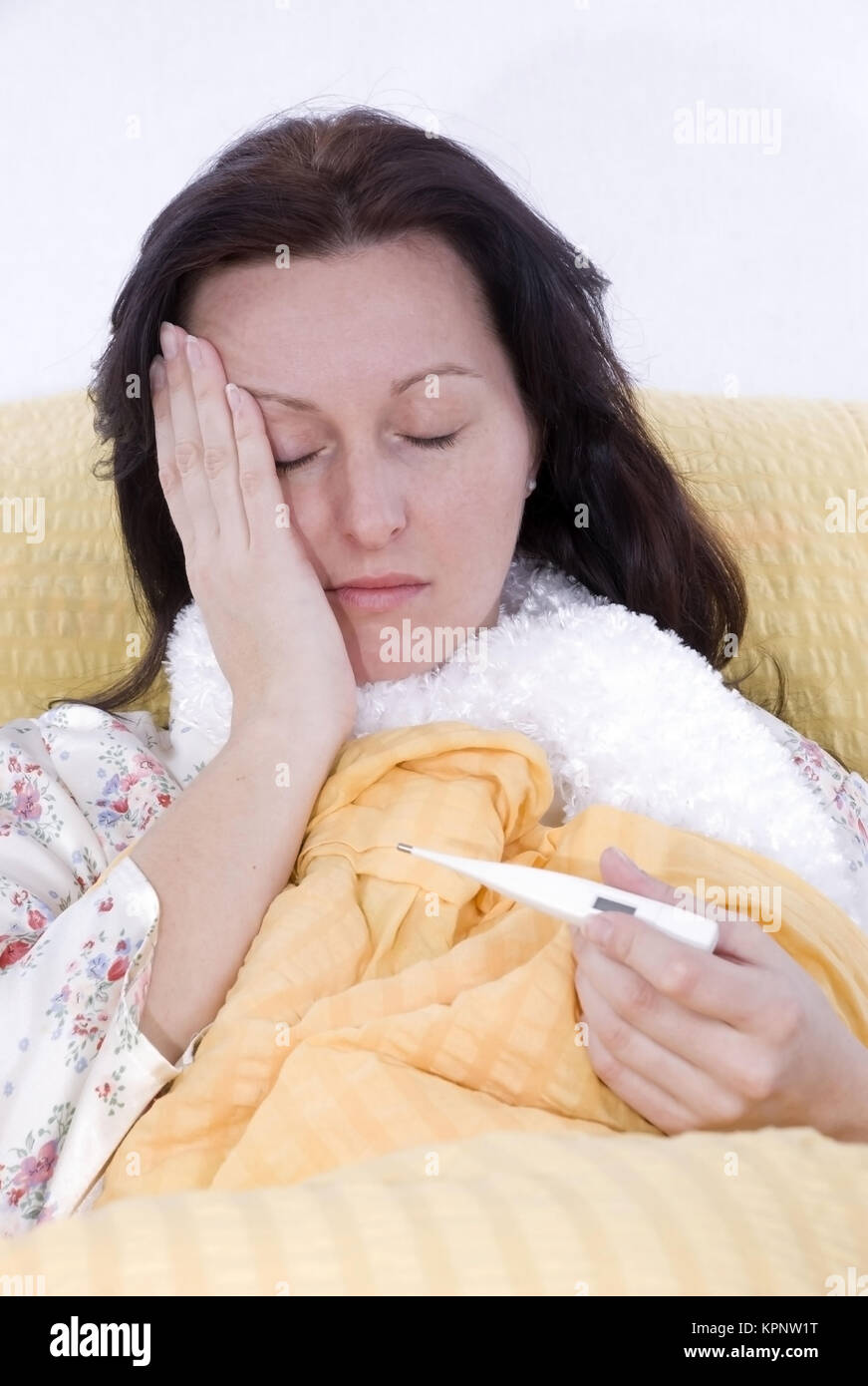 Model release , Junge Frau liegt mit Fieber im Bett - young, sick woman in bed Stock Photo