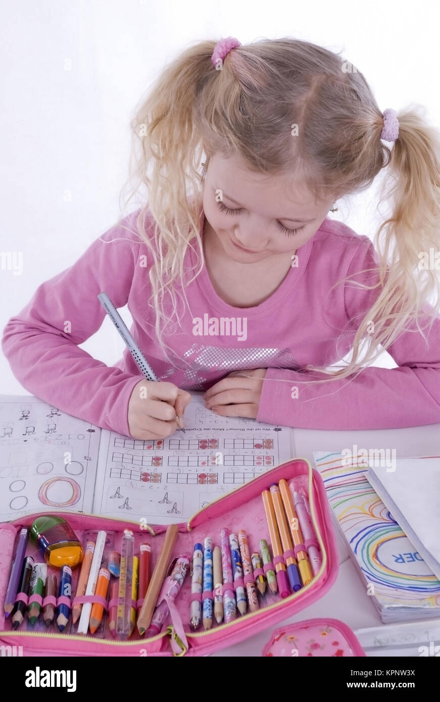 Model release , Schulmaedchen, 7 Jahre, macht Hausaufgabe - school girl does homework Stock Photo