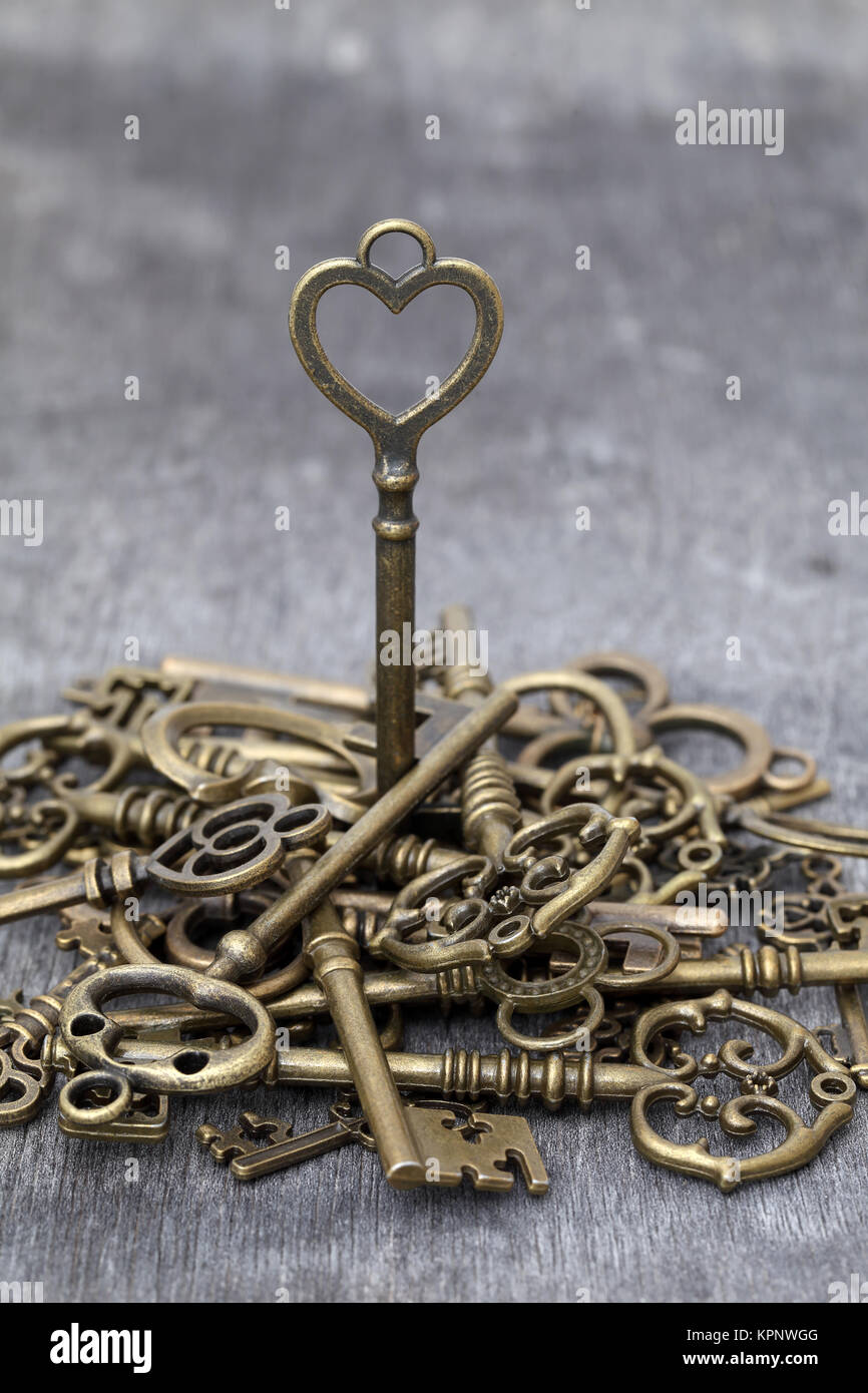 antique rusty key on grunge wooden background Stock Photo - Alamy