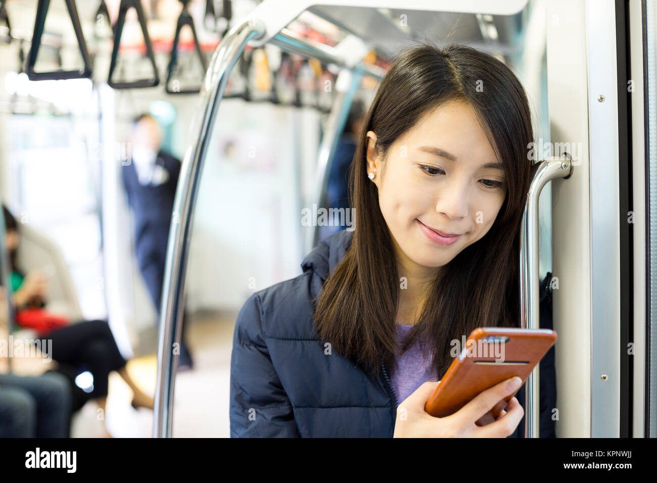 Woman use of cellphone inside train compartment Stock Photo