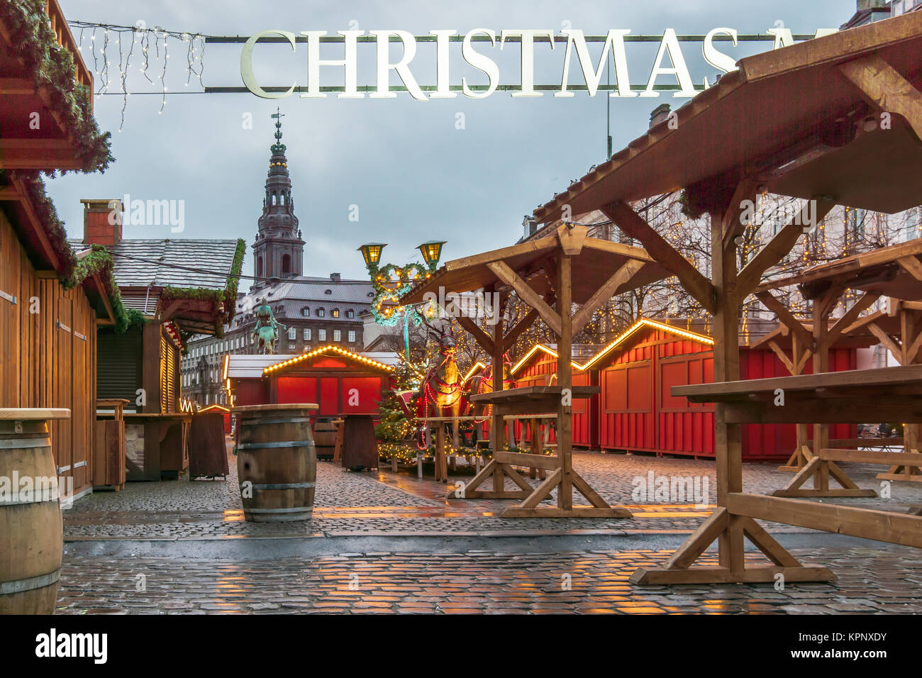Market-place with a Christmas banner over the square and red woodsheds at Amager an early morning, Copenhagen, Denmark, December 6, 2017 Stock Photo