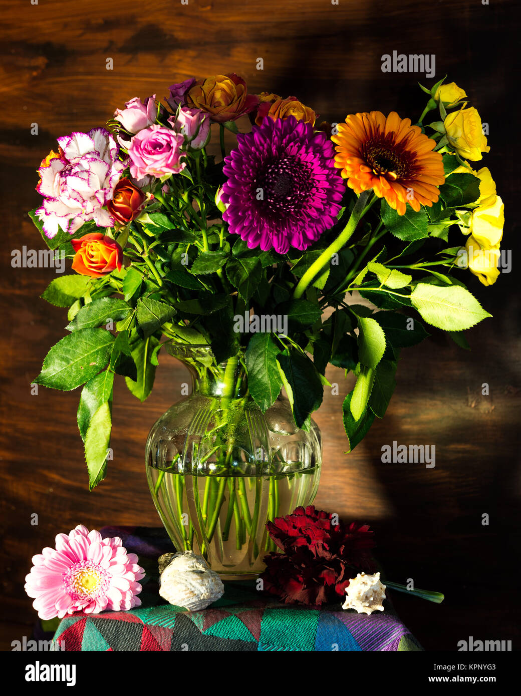 Flower still life with glass vase and a colourful bouquet of flowers Stock Photo