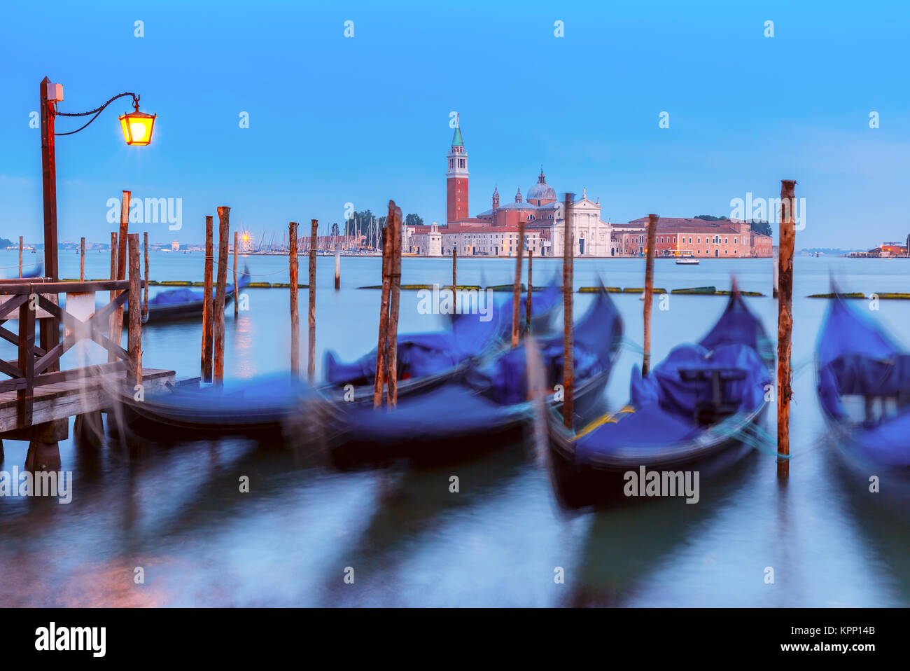 Gondolas at twilight in Venice lagoon, Italia Stock Photo - Alamy