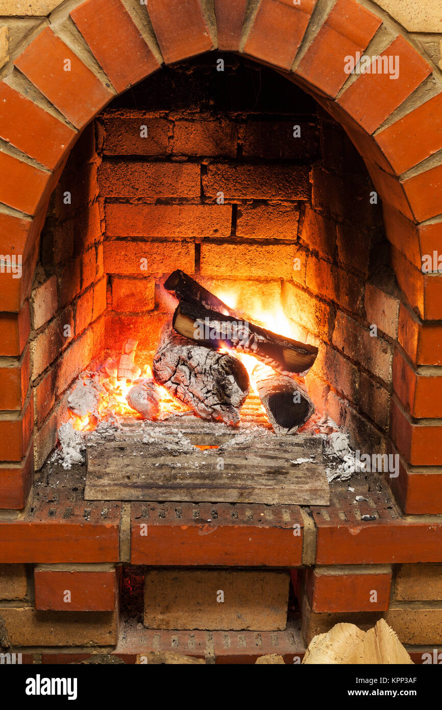 ash, coal and burning billets in fireplace Stock Photo Alamy