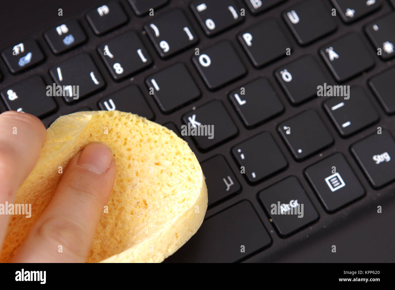 Cleaning a keyboard in the office with a sponge Stock Photo