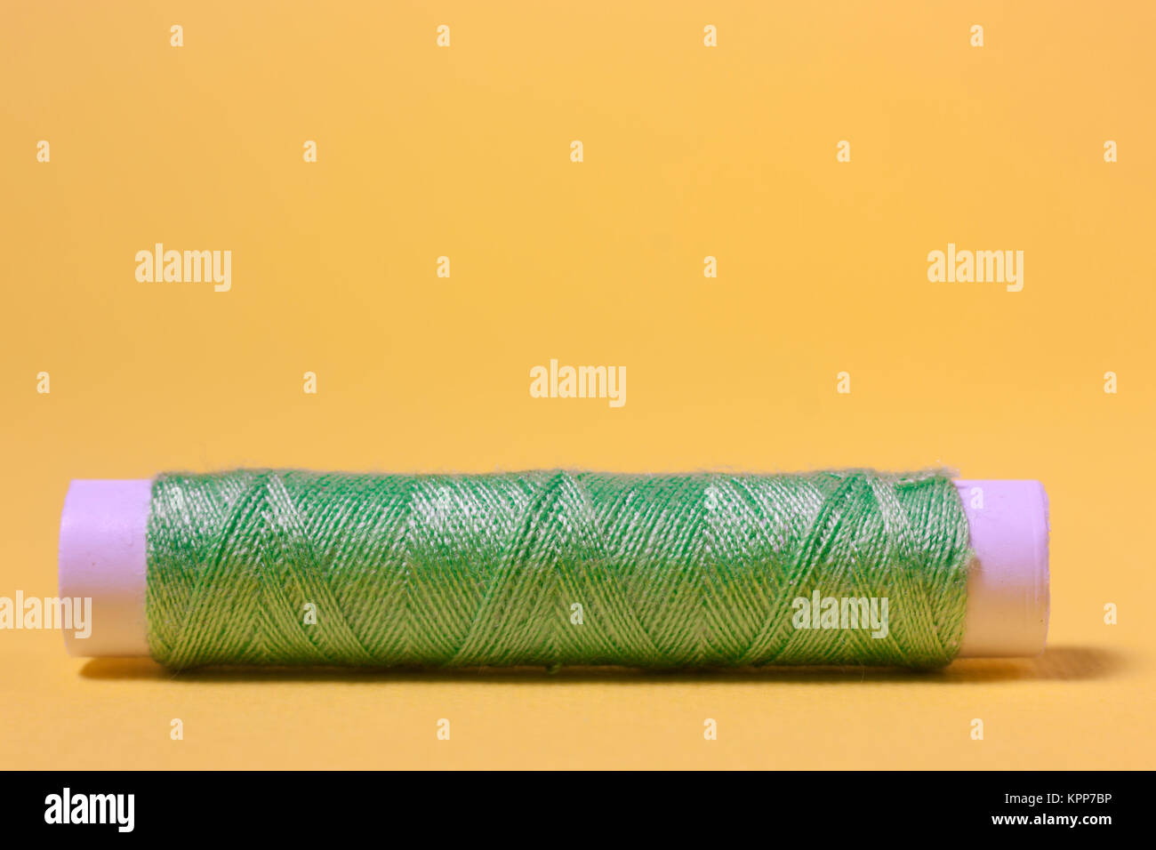 Spools of sewing thread isolated on gray Stock Photo - Alamy