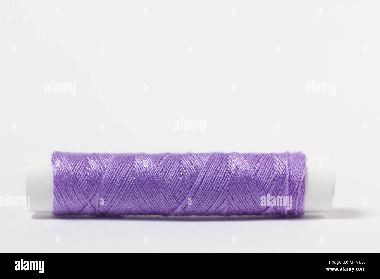 Spools of sewing thread isolated on gray Stock Photo - Alamy
