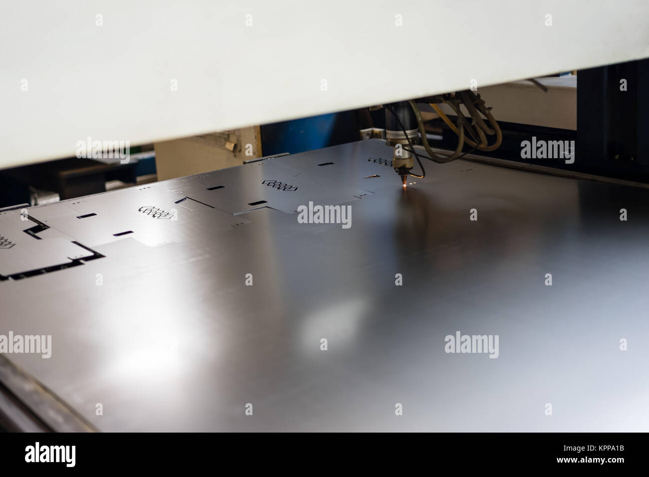 cutting stencilled patterns into metal Stock Photo Alamy