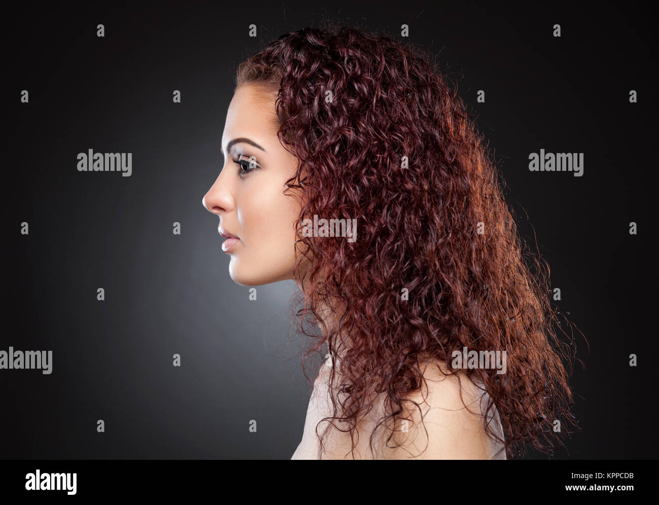 Beautiful woman with red curly hair Stock Photo - Alamy