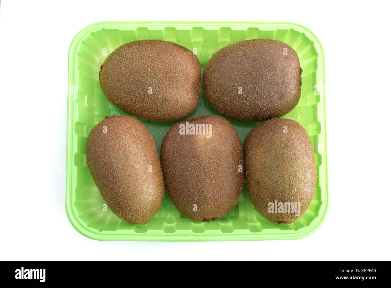 Five Kiwi fruits in a green box isolated on white background Stock Photo