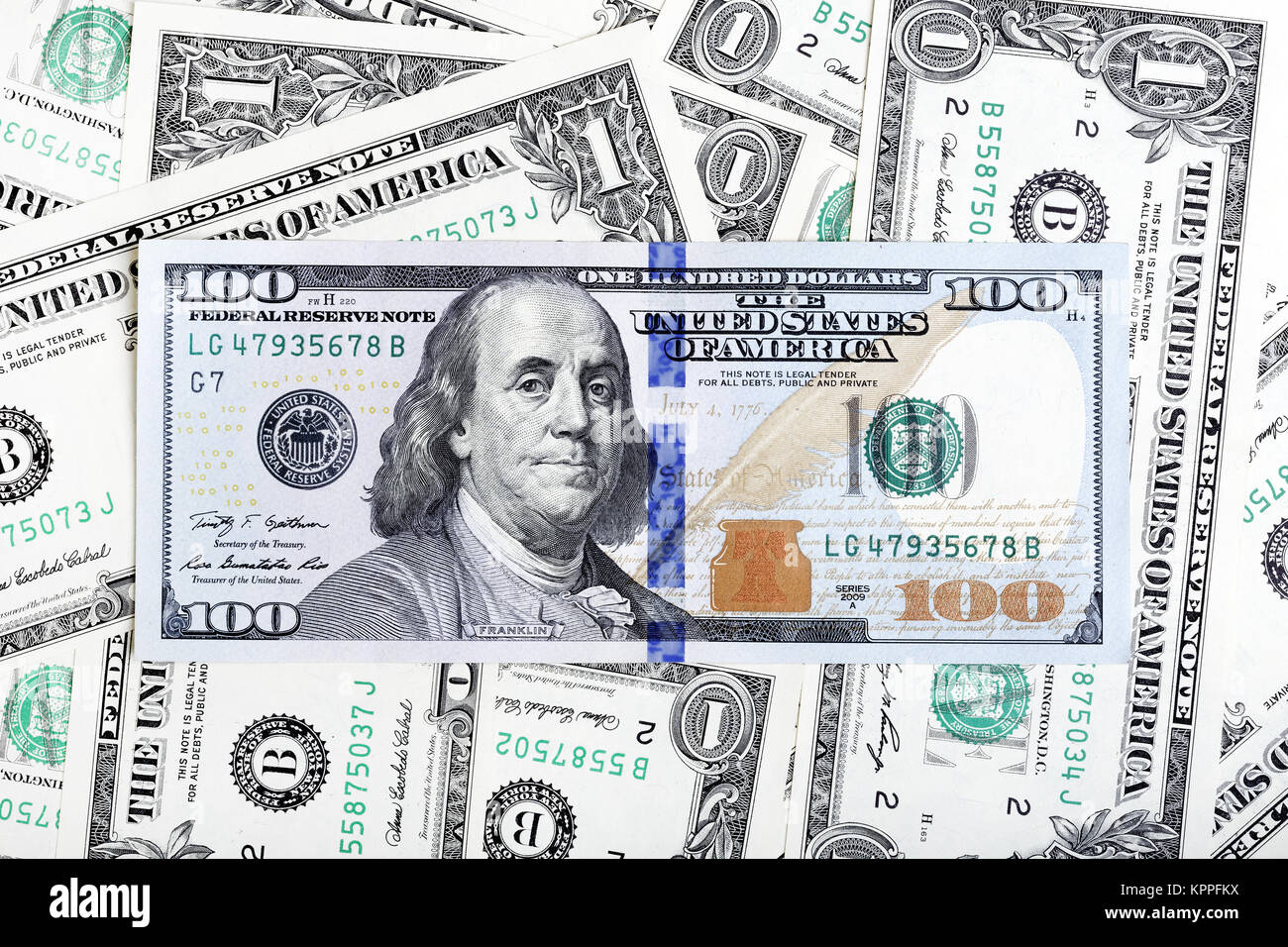 One dollar bills and hundred dollar banknote macro photo. Stock Photo