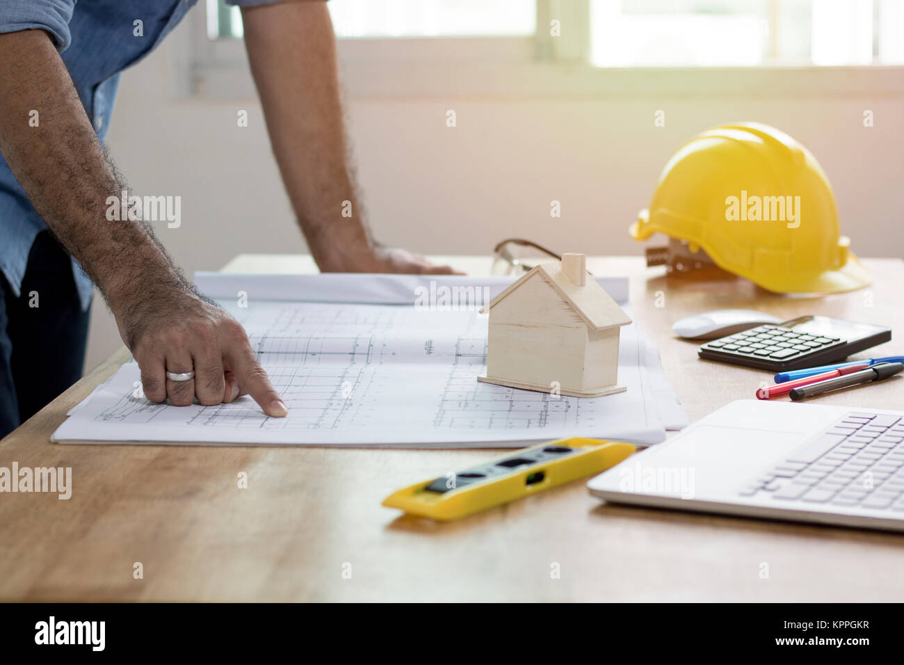 Enginee or architect  ponting and looking on plan paper on desk, architect and working concept Stock Photo