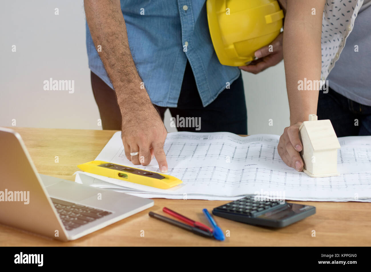 Enginee or architect  looking and pointing on plan paper on desk, architect and working concept Stock Photo