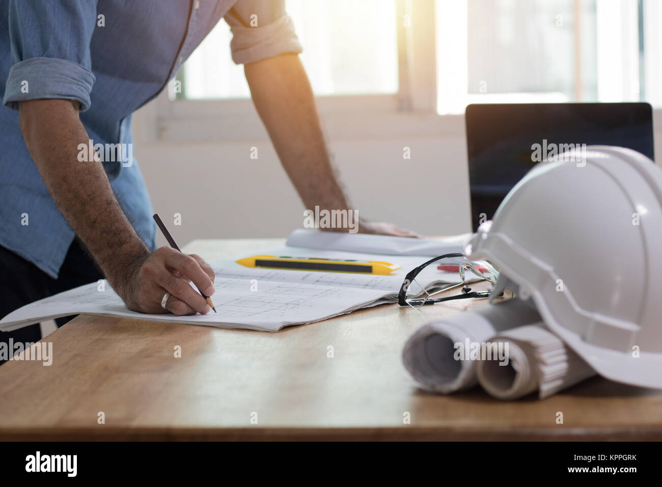 Enginee or architect  drawing and writing on plan paper on desk, architect and working concept Stock Photo
