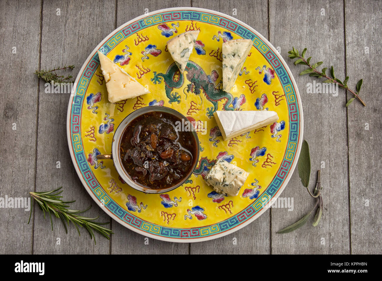 Plate with assortment of cheeses and home made herbal chutney Stock Photo
