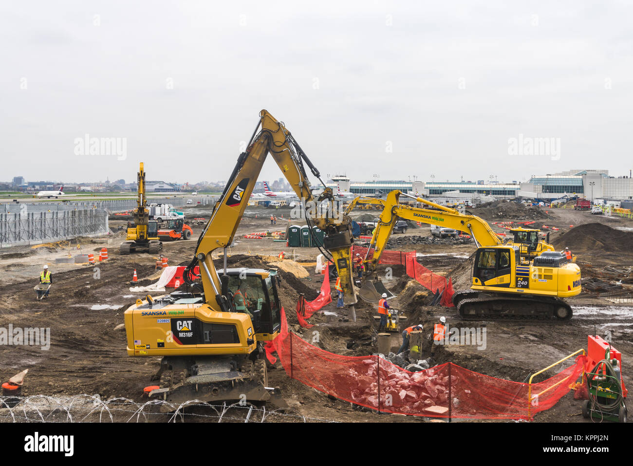 Construction equipment and workers building the new terminal at La