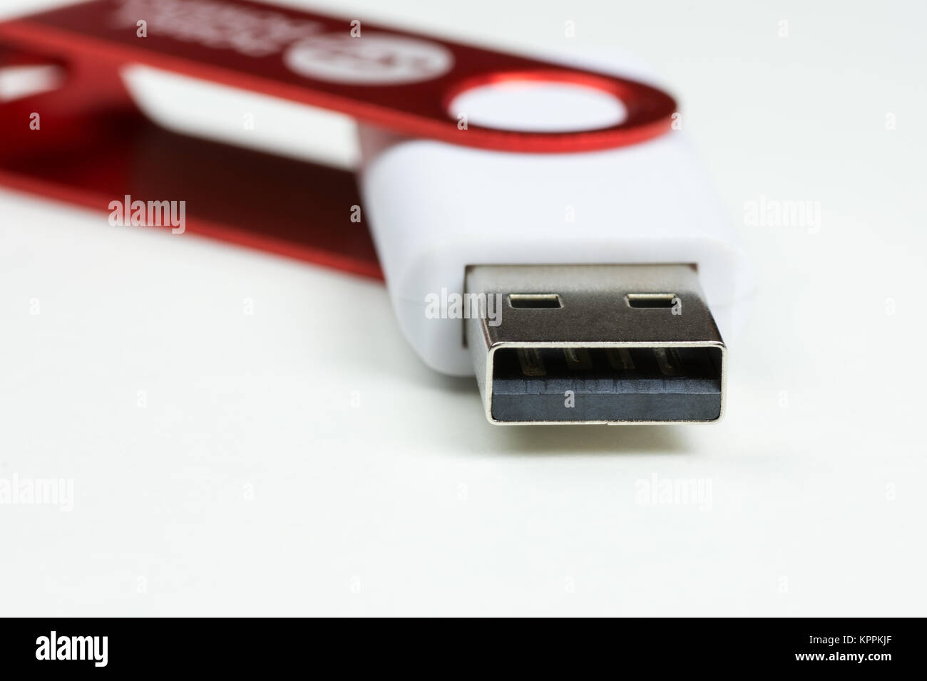 Close-up view of a white USB Flash Drive connector with red cap, on a white background Stock Photo