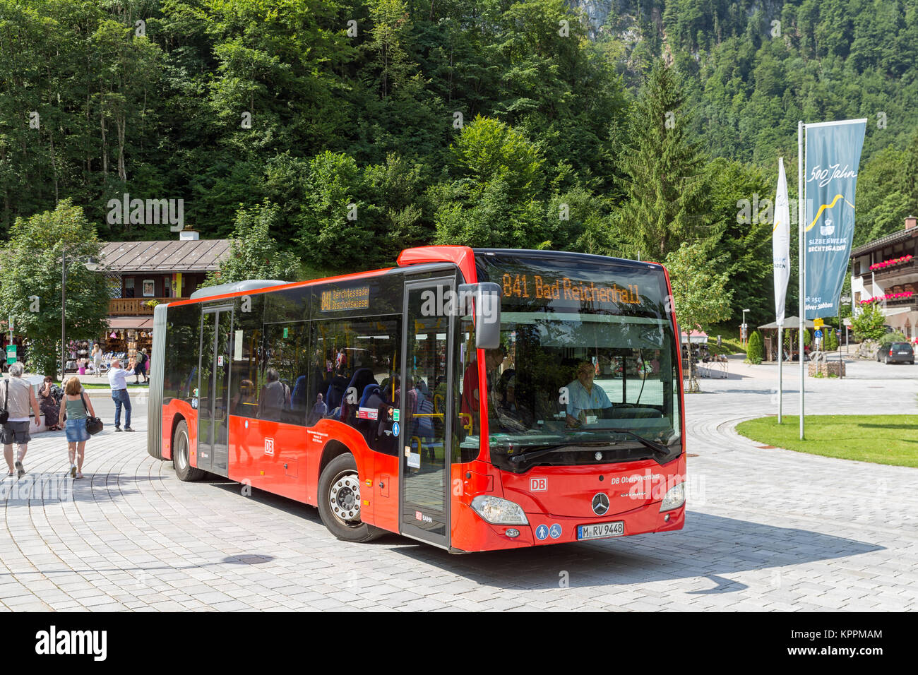 Coach with passengers leaving bus-stop in Berchtesgaden near the Konigssee Stock Photo