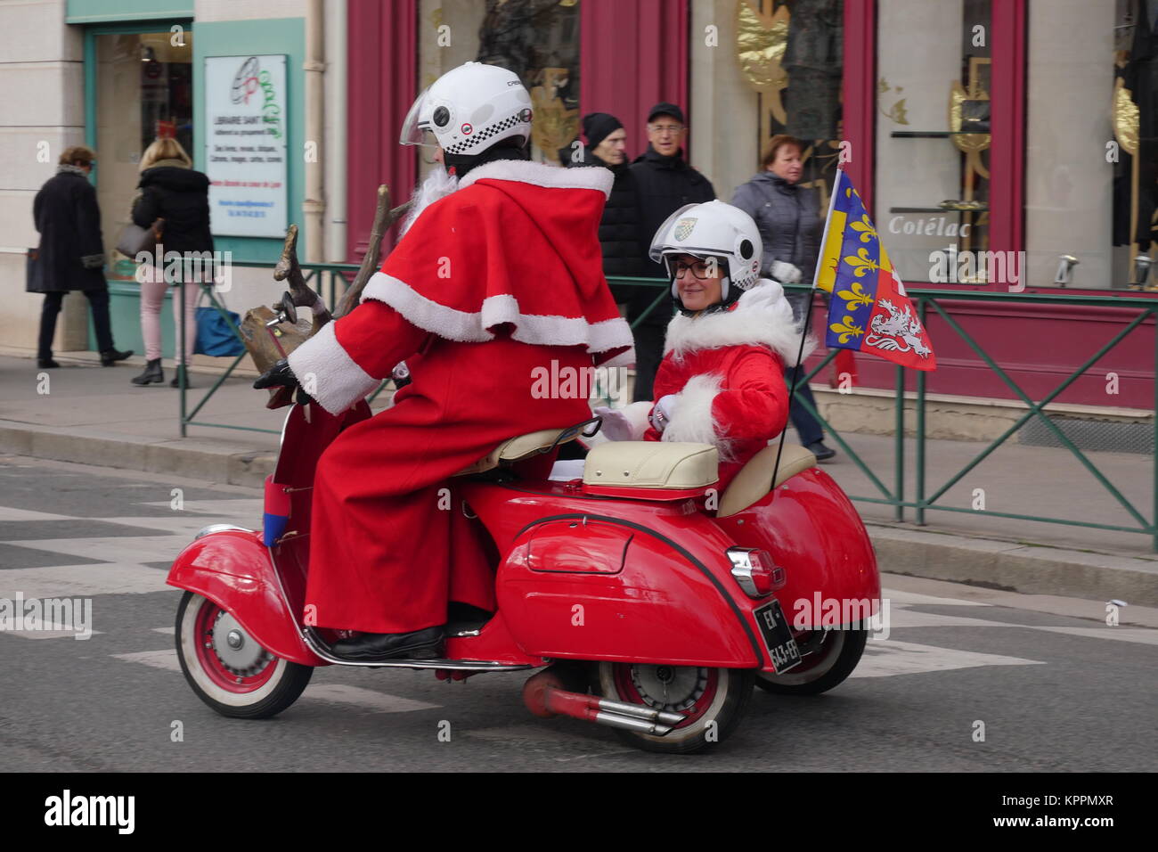 Santa-Claus riding red scooter, Lyon, France Stock Photo