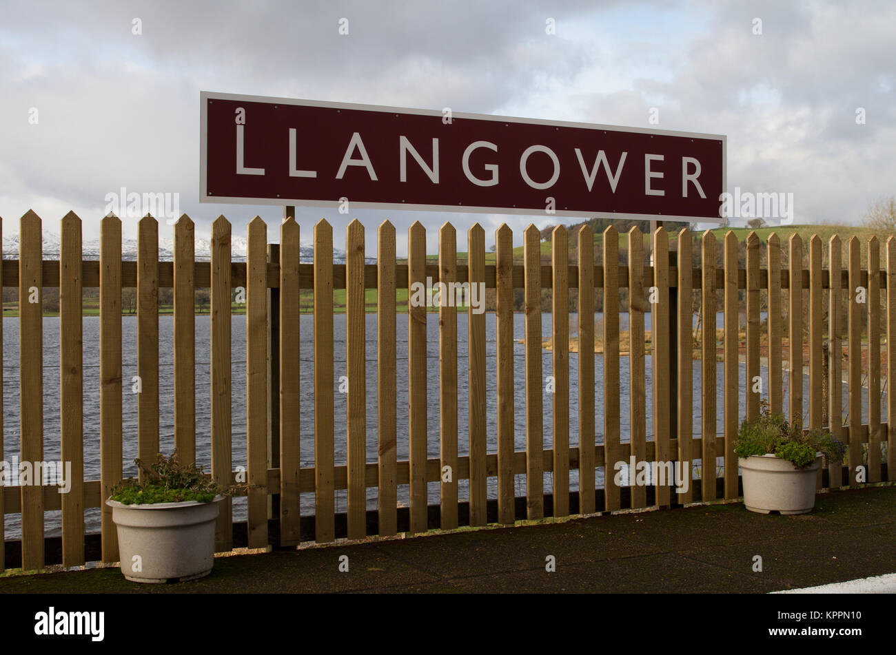 Llangower Railway Station, Bala Lake Railway with station name board, Lake and Mountains behind, Winter planting in pots Stock Photo