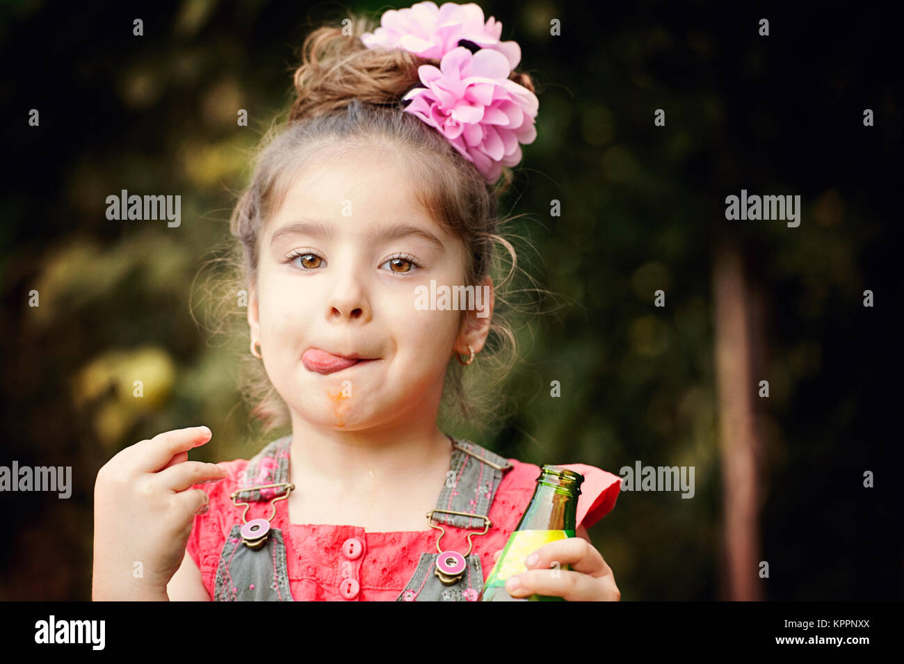 Little girl drinking orange juice Stock Photo - Alamy