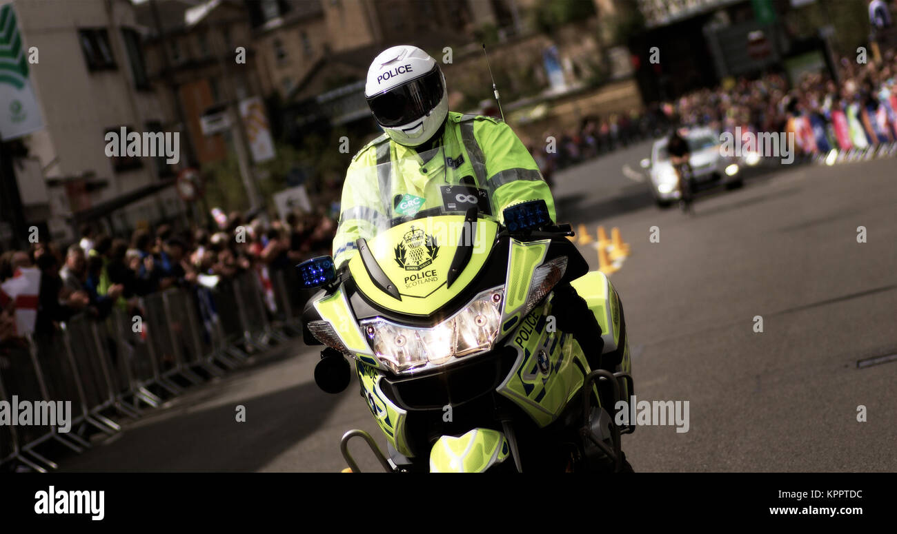 Police Scotland motorcycle officer escorting cyclists competing in a race at the Glasgow 2014 Commonwealth Games, Glasgow, Scotland, 31st July, 2014 Stock Photo