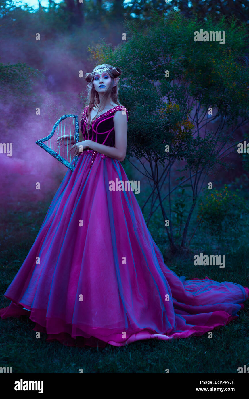 Elf woman in violet dress Stock Photo