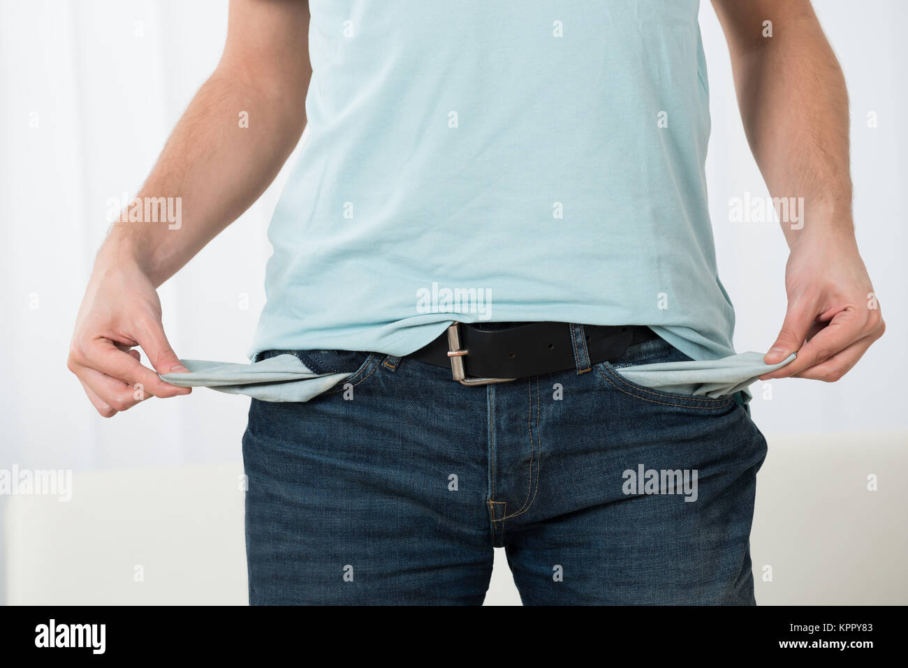 Young Man Showing Empty Pockets Stock Photo Alamy