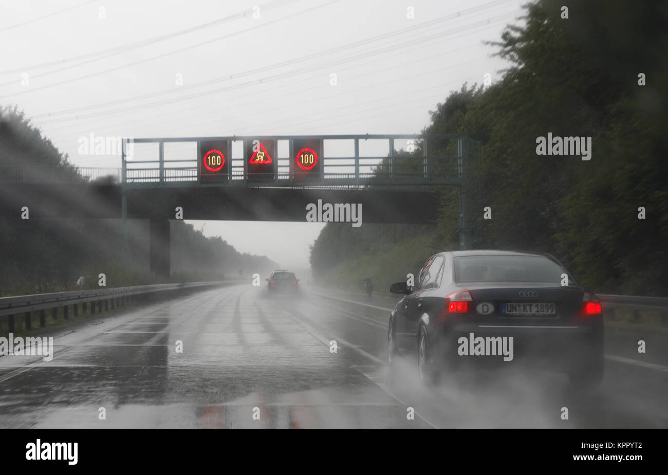 Germany, motorway A 44 near Werl, overtaking during a rain shower.  Deutschland, Autobahn A 44 bei Werl, Ueberholvorgang bei Regen. Stock Photo