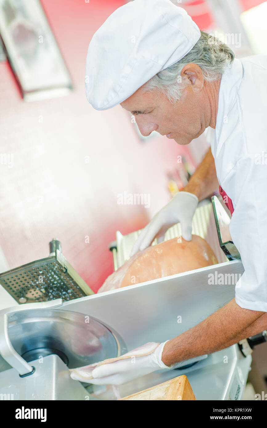 Butcher slicing ham Stock Photo Alamy