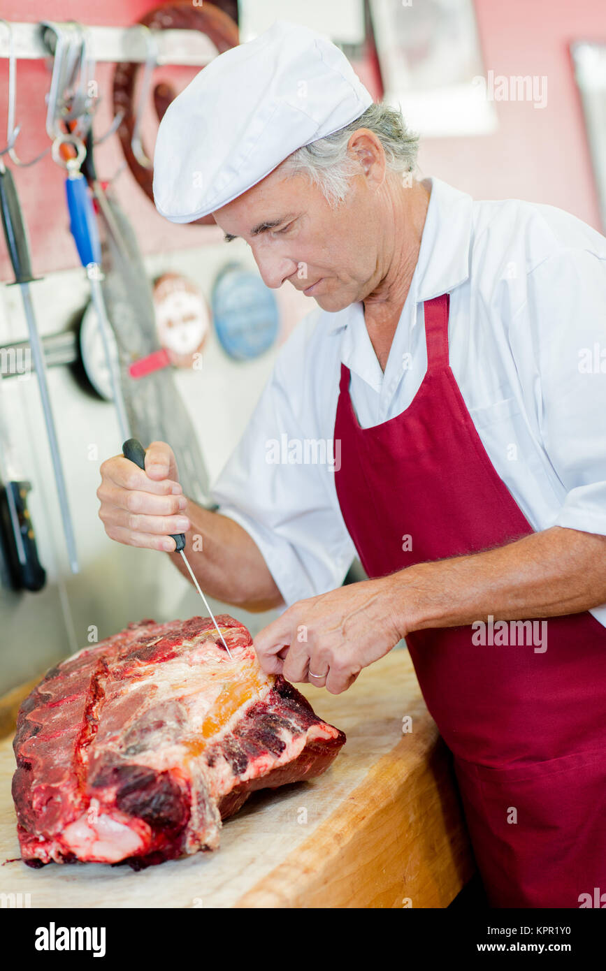 Experienced chef cutting beef Stock Photo