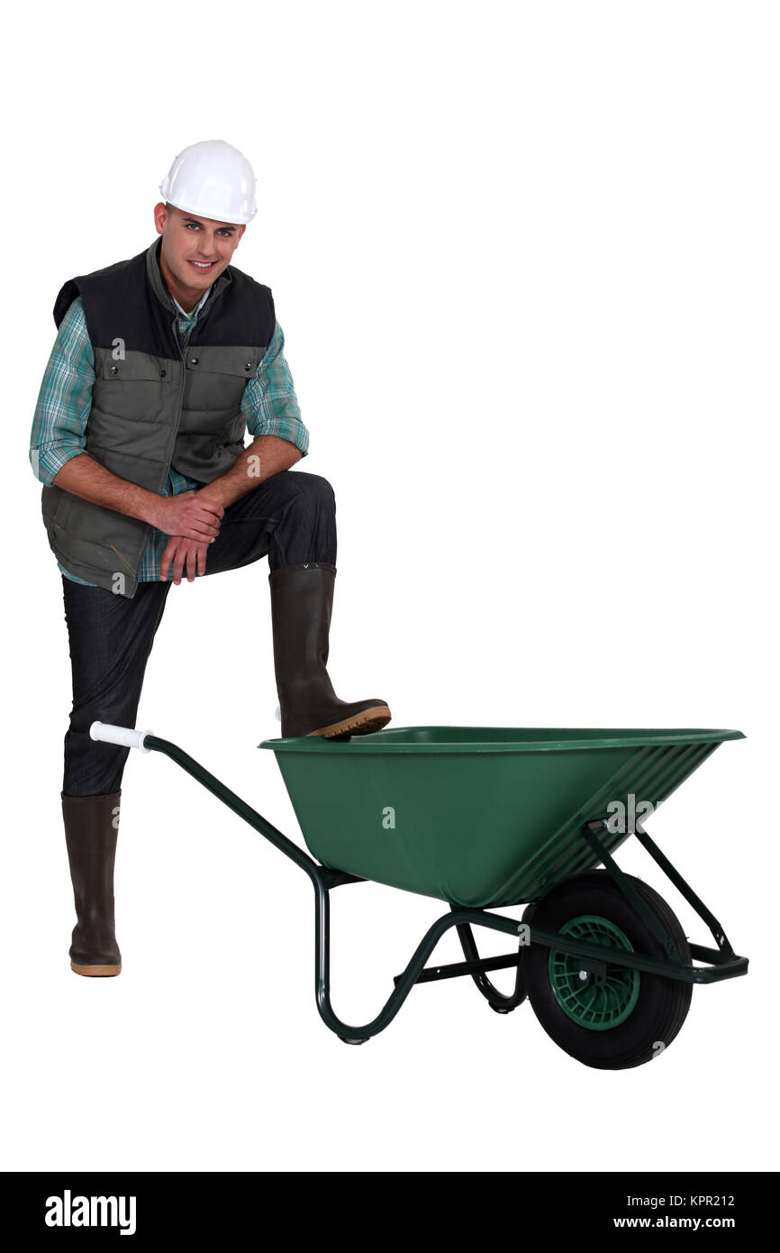 Construction worker with empty wheelbarrow Stock Photo